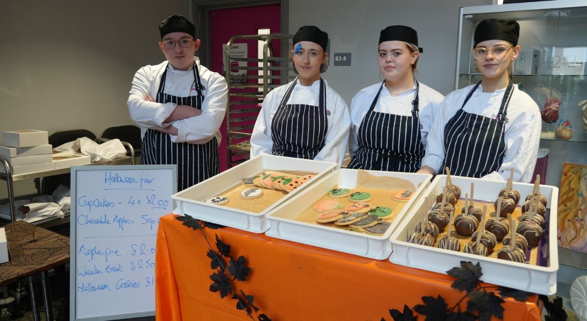 Image showing four students at the 2025 Halloween market 